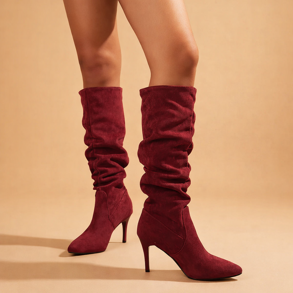 Women's slouch knee-high stiletto boots in black faux leather.