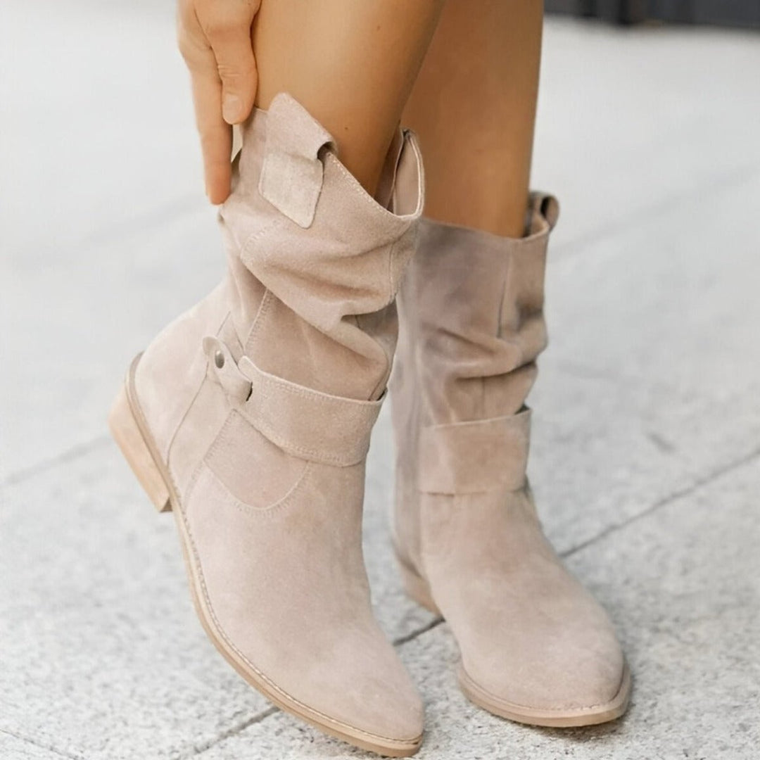 Close-up of women's slouchy knee-high boots, highlighting the comfortable block heel and soft material.