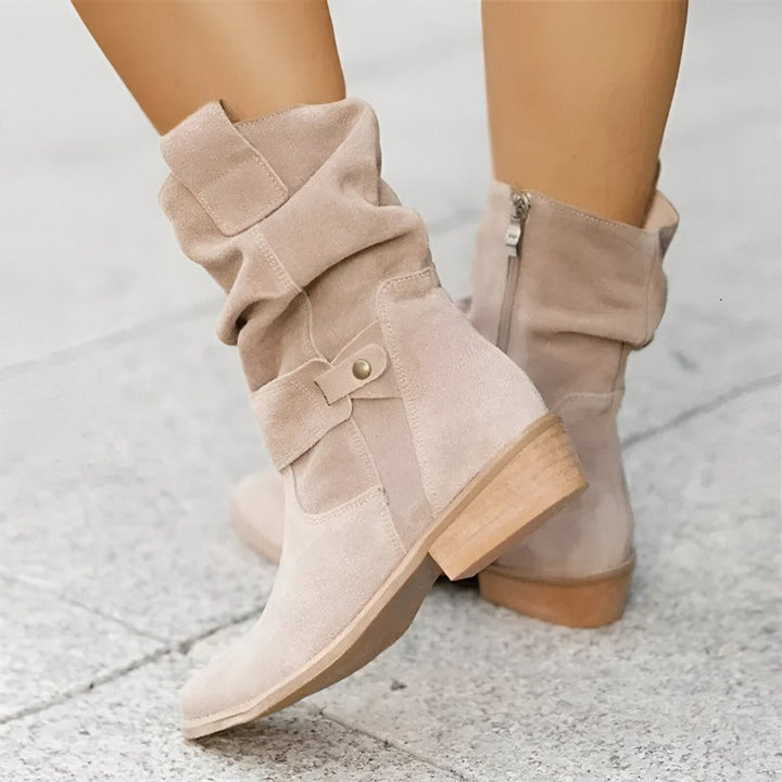 Fashionable women's slouch boots with comfortable block heel, designed as versatile knee-high footwear for any season.