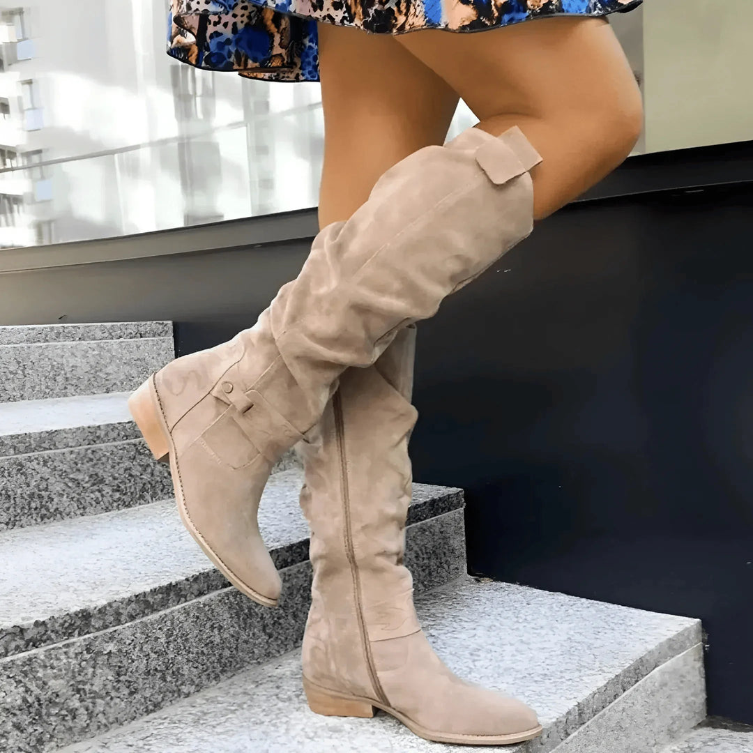 Women's slouchy knee-high boots with side zipper and decorative buckle detail, perfect for autumn fashion.