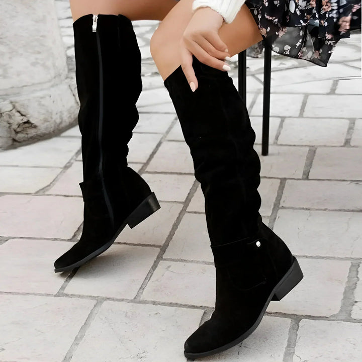Comfortable women's slouchy knee-high boots, with a side zipper and decorative buckle for versatile styling.