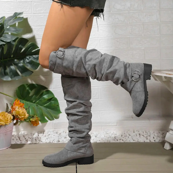 Chic women's slouchy knee-high boots, elegant with a buckle accent & practical lug sole. Great for fall fashion.