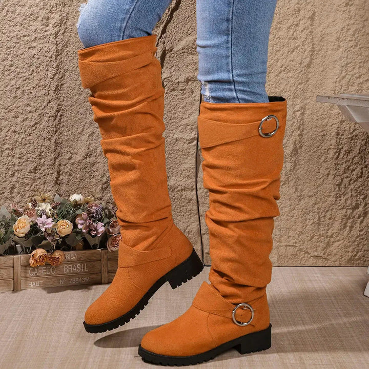 Premium women's slouchy knee-high boots with an elegant buckle & a rugged lug sole. Ideal for winter chic footwear.