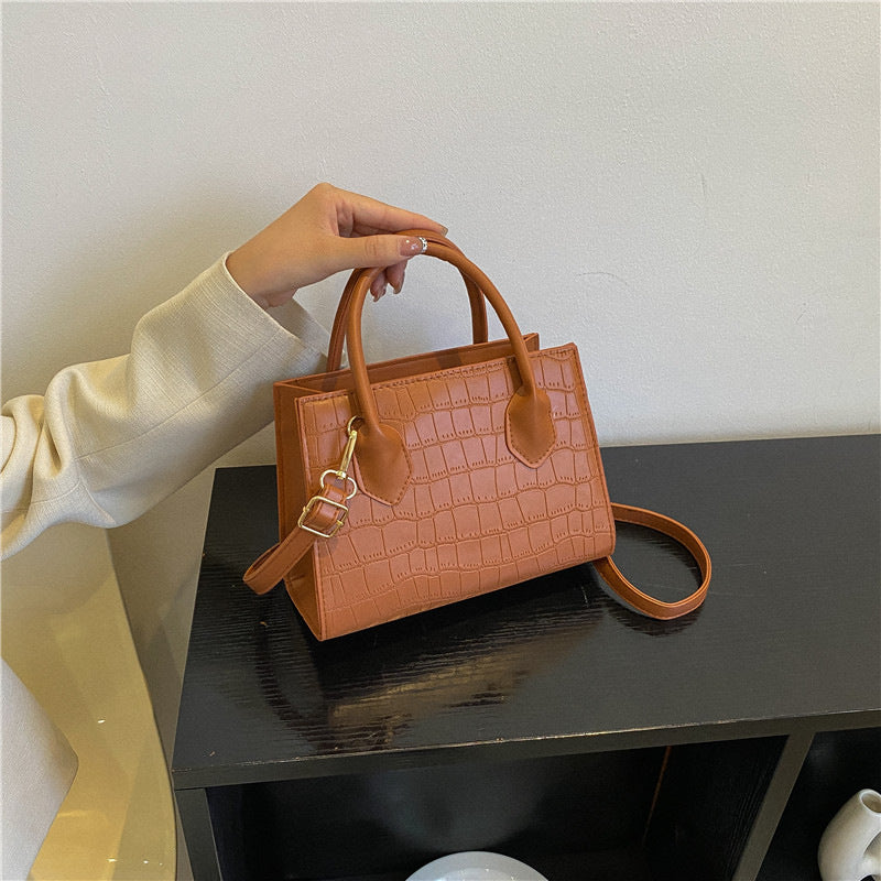 Versatile women's small khaki clutch handbag for daily use, a chic fashion accessory.