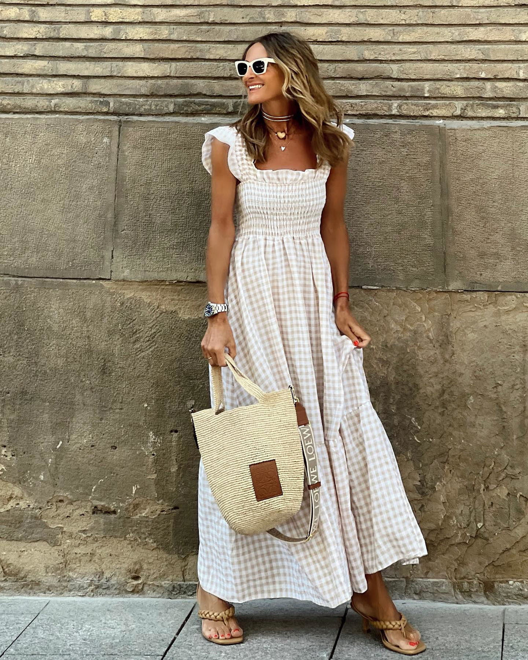 Women's smocked & tiered gingham maxi dress. Effortless style for summer & spring casual wear.