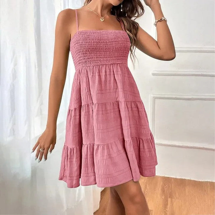 Stylish smocked mini sundress, tiered silhouette, comfortable fit for women's summer fashion.