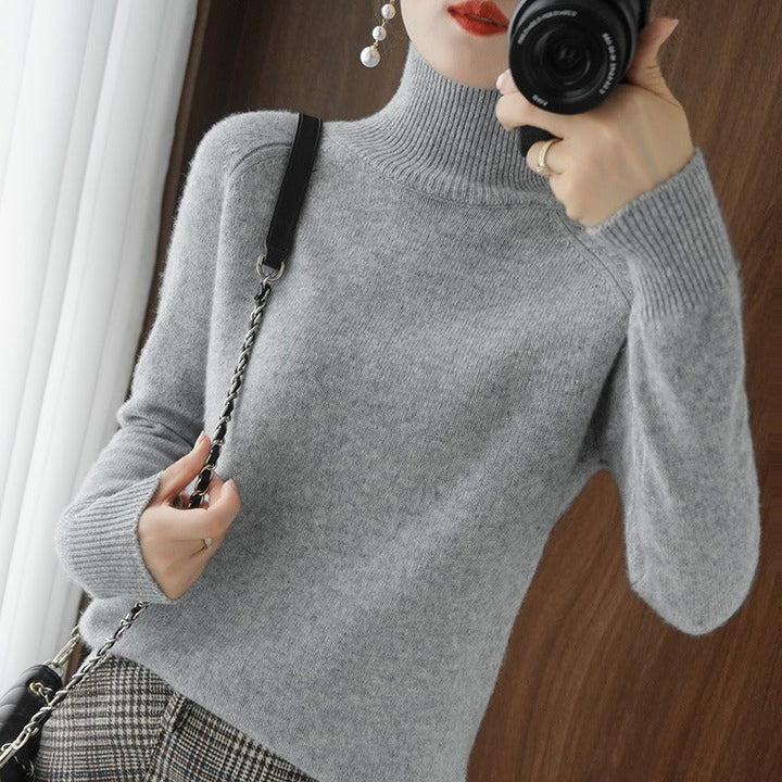 Chic women's smooth turtleneck sweater, an essential long-sleeve pullover for comfortable cold-weather layering.