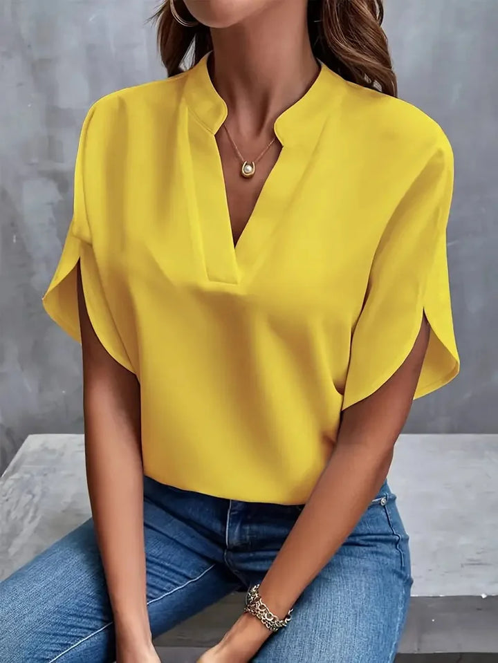 Elegant women's blouse with a V-neck and relaxed long sleeves, offering stylish versatility.