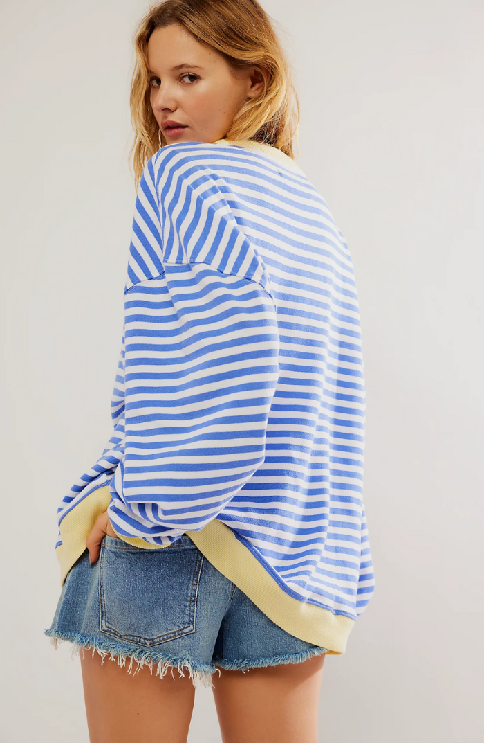 Close-up of a women's striped crewneck sweater, highlighting soft fabric & classic pattern.