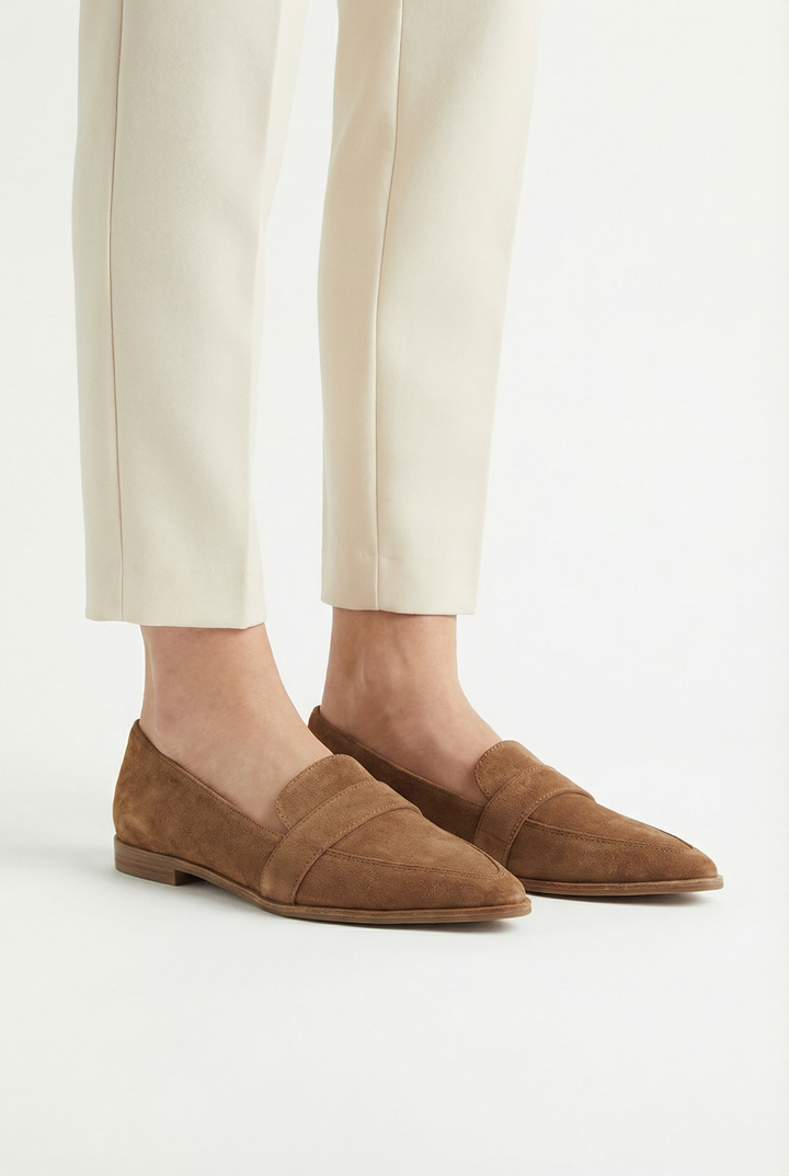 Woman wearing grey suede everyday loafers, showcasing versatile footwear