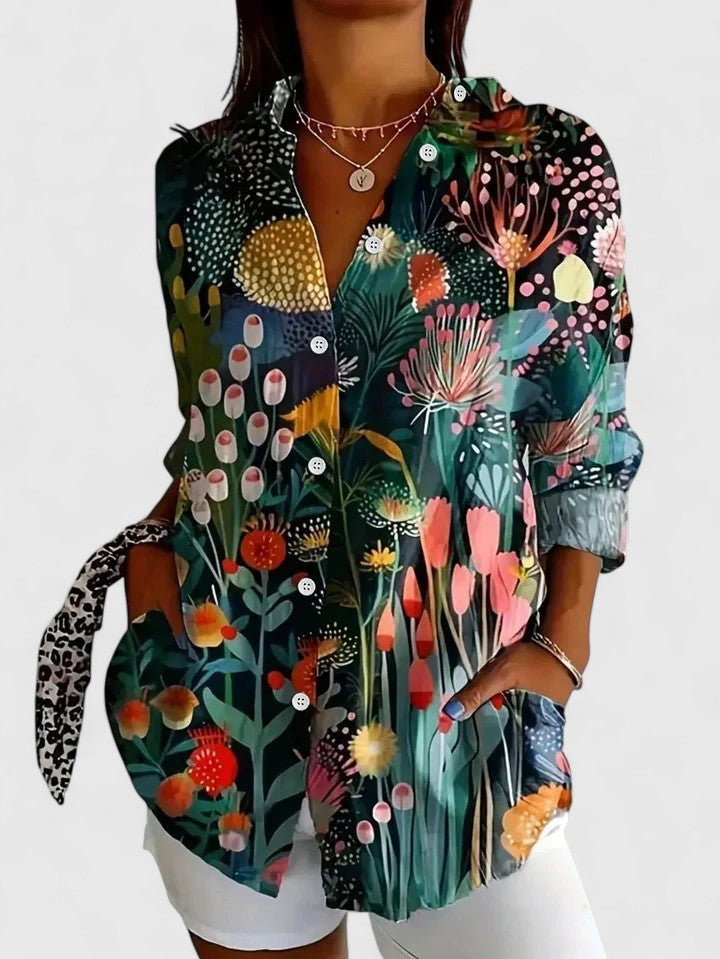 Sophisticated women's blouse featuring a vibrant, colorful print; an elegant and comfortable top for spring/summer fashion.