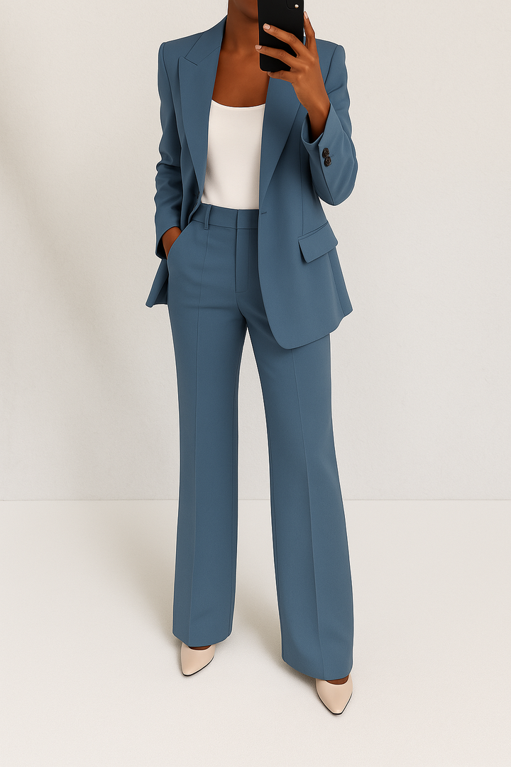 Professional women's business pant suit. Tailored blazer & flat-front trousers, perfect for office attire.