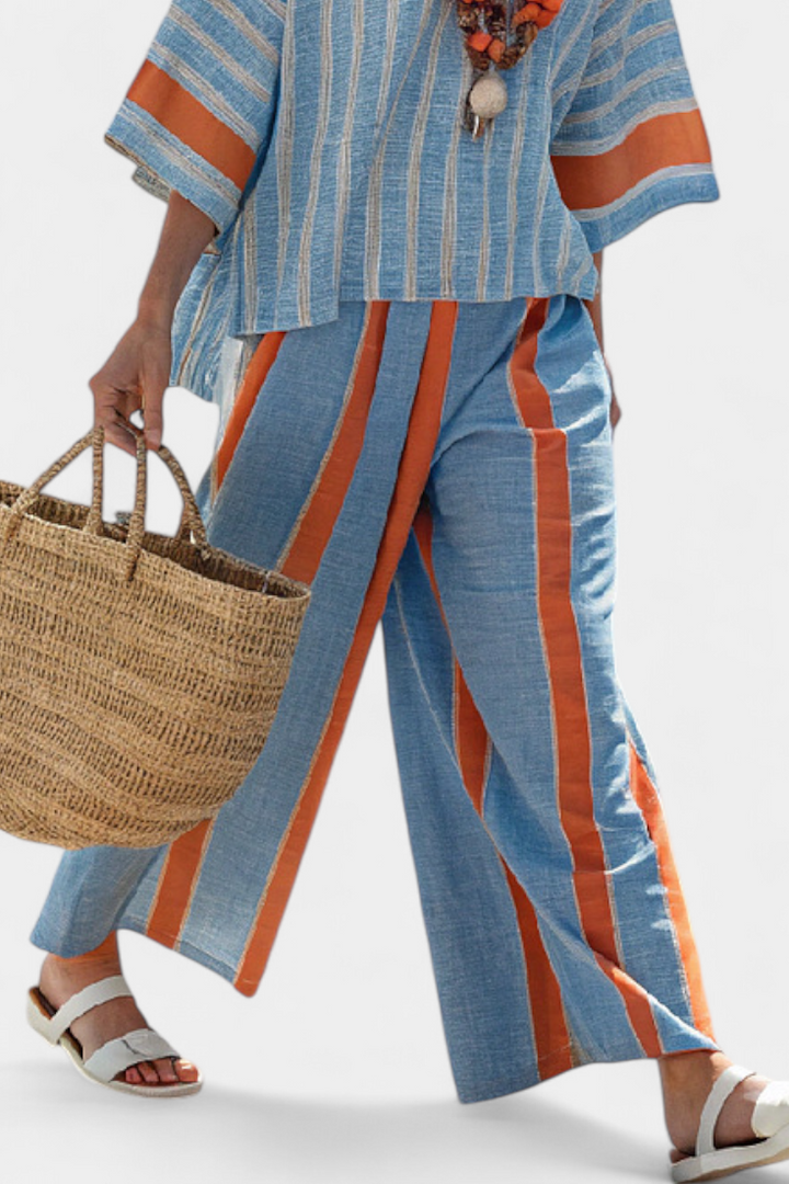 Terracotta striped women's two-piece set featuring a relaxed top & wide-leg trousers. Elegant casual summer outfit.