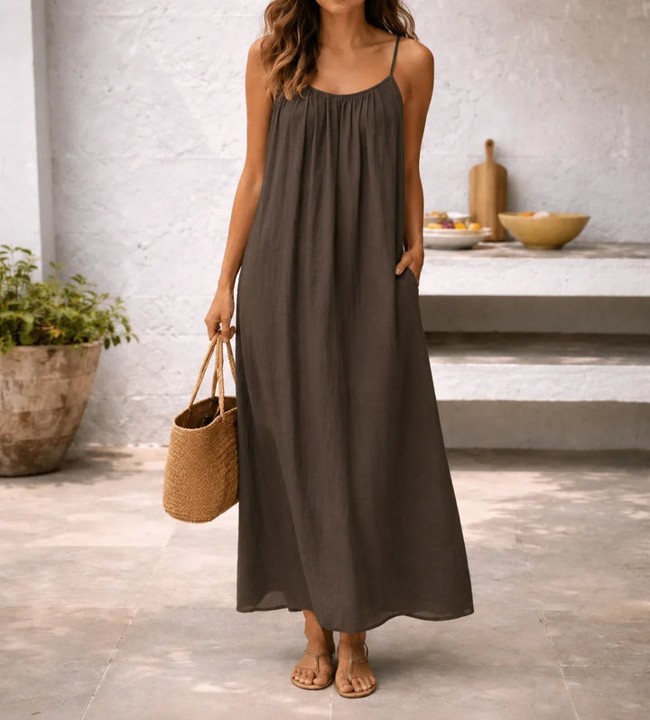 Women's spaghetti strap maxi dress with convenient pockets, perfect for casual summer wear & vacation.