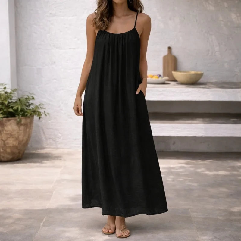 Comfortable women's summer maxi dress featuring spaghetti straps & pockets, great for casual outings.