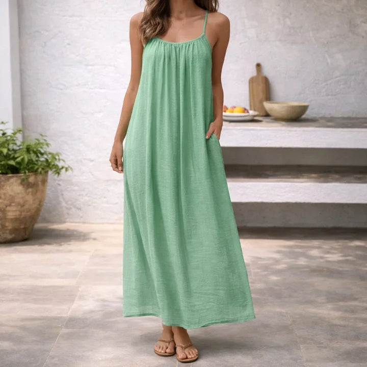 Elegant women's spaghetti strap maxi dress, a versatile piece with pockets for vacation and resort wear.