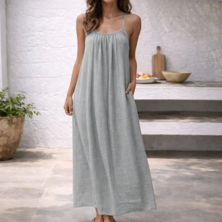 Adjustable spaghetti strap maxi dress for women, with comfortable flowy design & practical pockets.