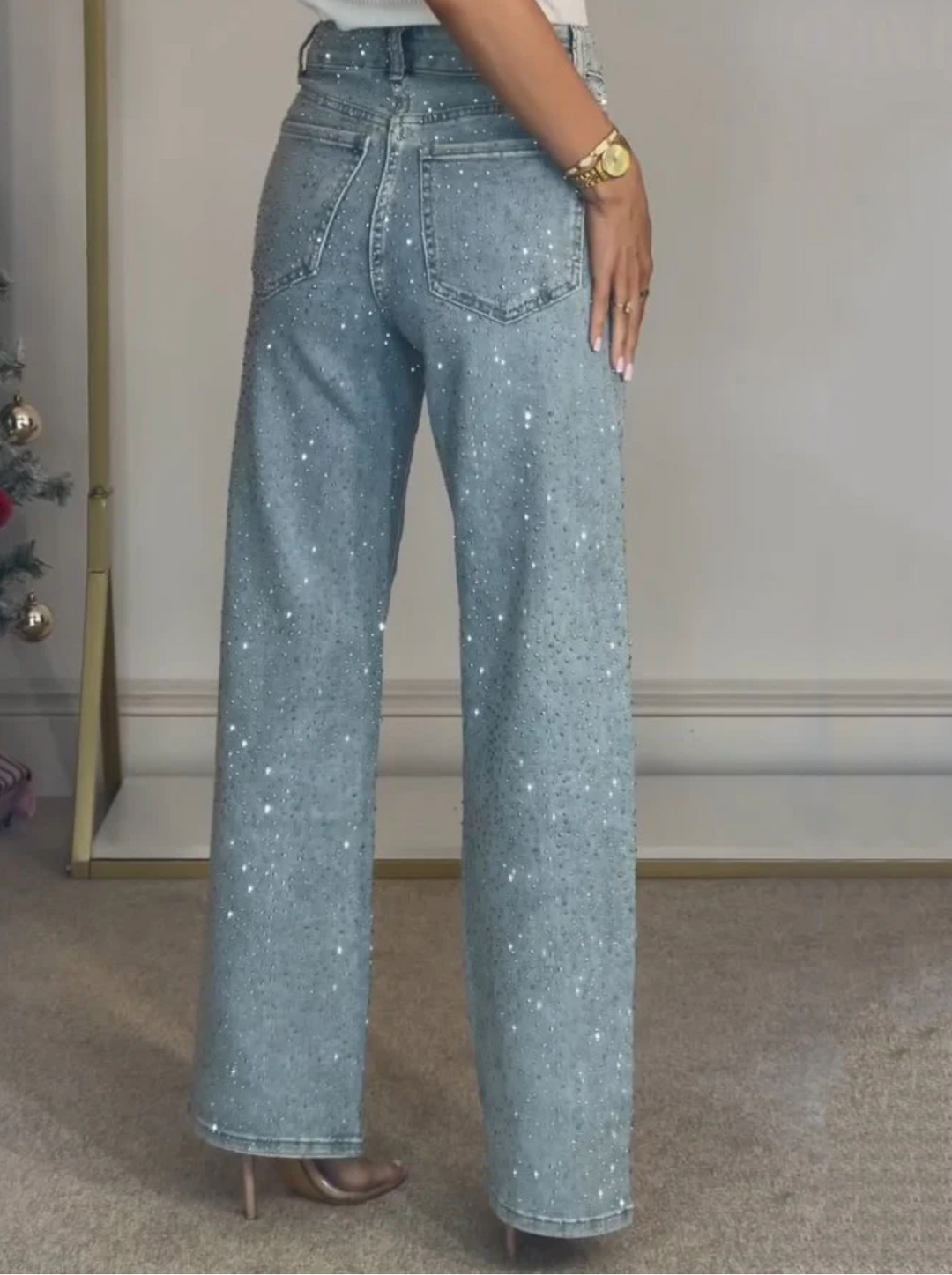 Model wearing high waist straight leg jeans with subtle sparkle detail
