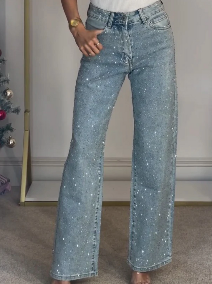 Fashionable women's blue denim jeans with high waist and straight leg cut