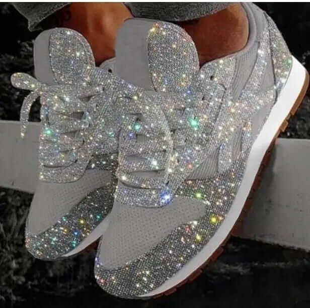 Side view of women's chunky platform glitter trainers, showcasing the thick sole & sparkling finish. Trendy height-boosting shoes.