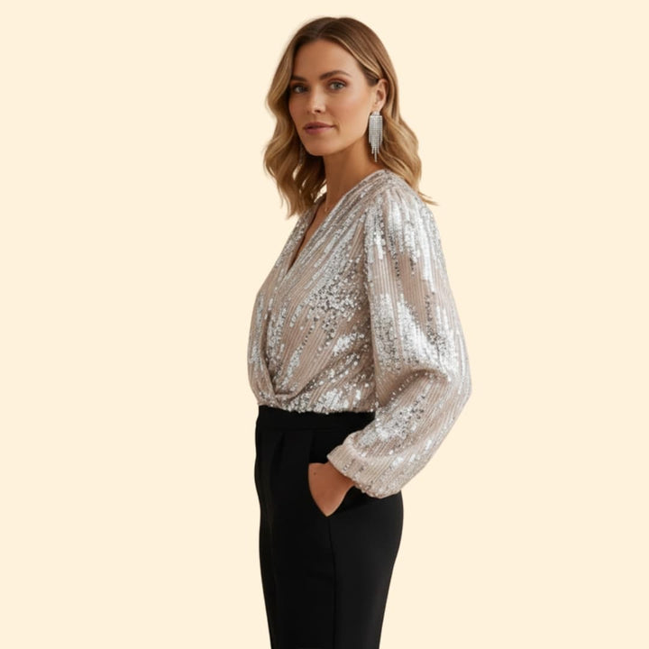 Statement women's gold sequin wrap blouse. Sparkling long sleeve V-neck top, ideal for stylish evening wear.