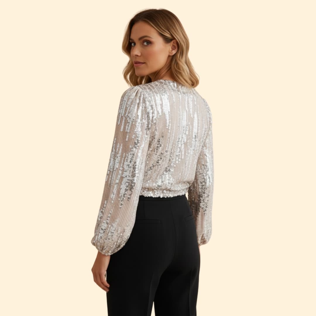 Stylish women's gold sequin wrap blouse. Long sleeve V-neck party top, perfect for a glamorous evening look.