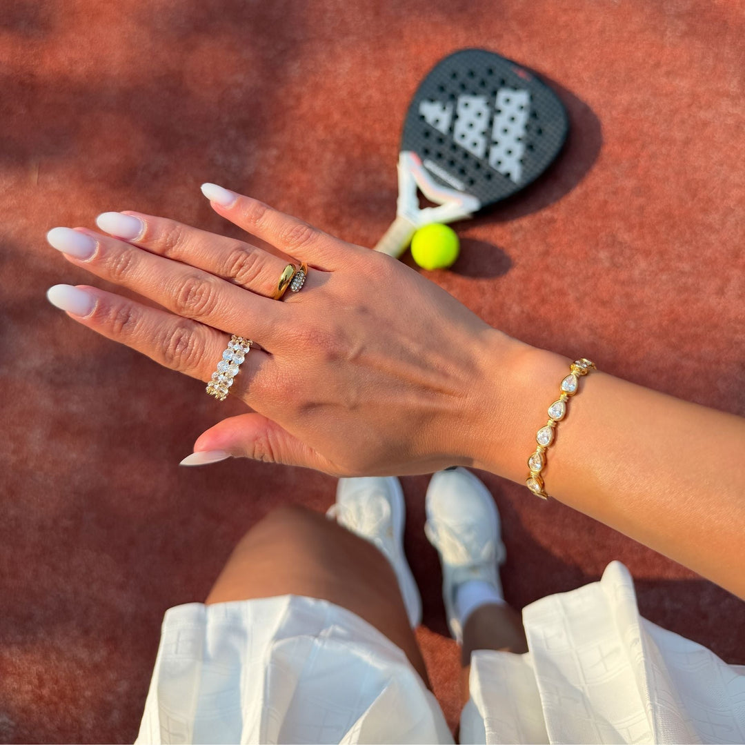 Luxury women's sterling silver padel bracelet, adorned with sparkling pear stones & gold vermeil accents.