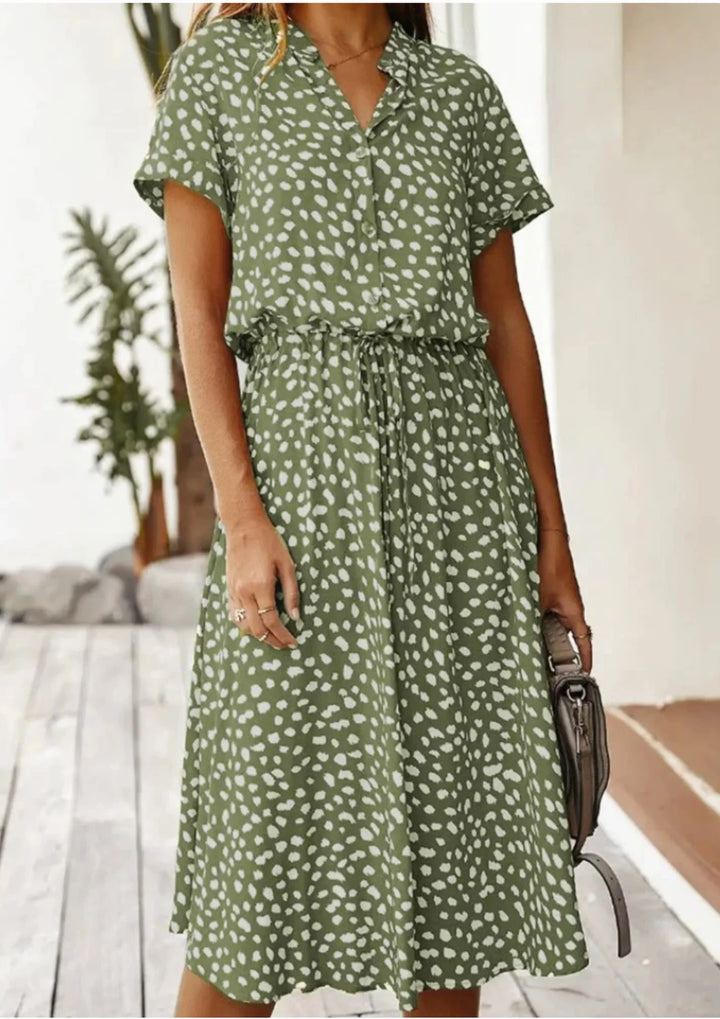 Summer-ready women's spotted print midi dress. Button-down, flutter sleeve, flattering drawstring waist.