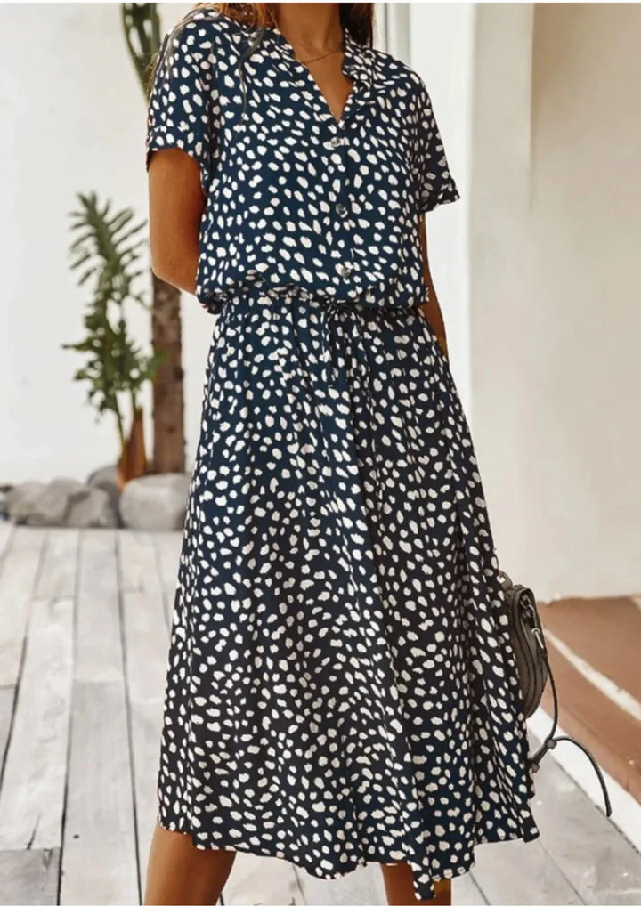 Flowy women's casual midi dress, spotted print. Features button-down closure & drawstring waist.
