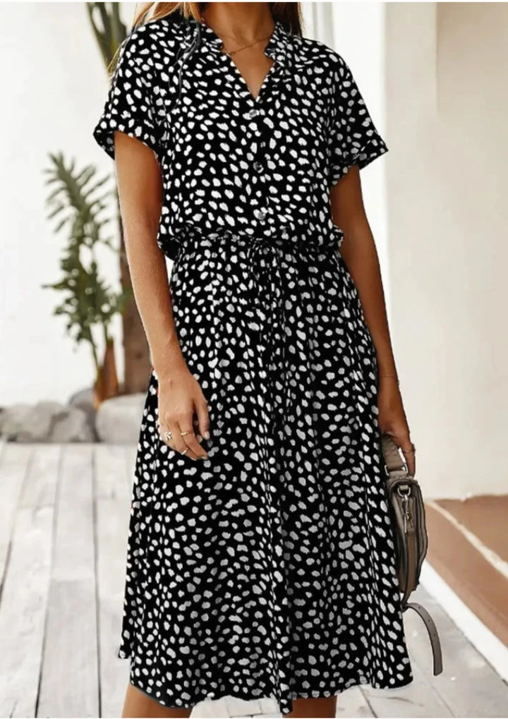 Elegant women's spotted print day dress. Button-down style, flutter sleeves & drawstring waist.