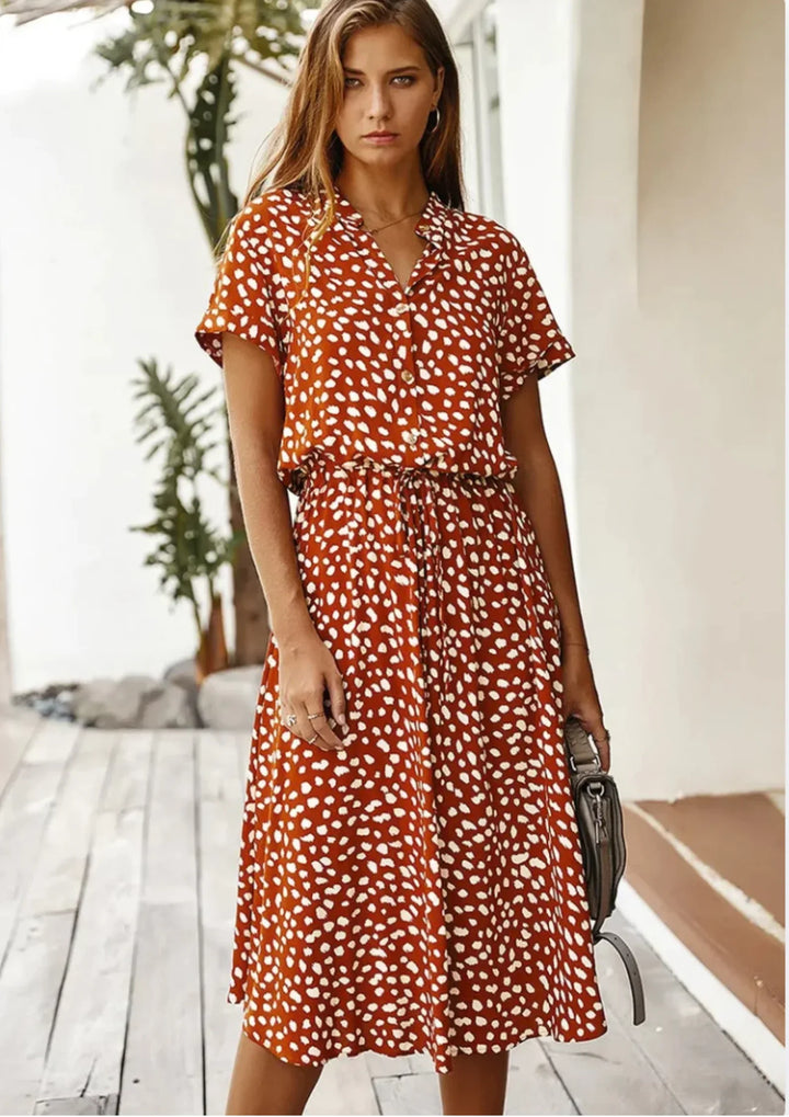 Casual summer midi dress for women. Spotted print, button-down, flattering drawstring waist.
