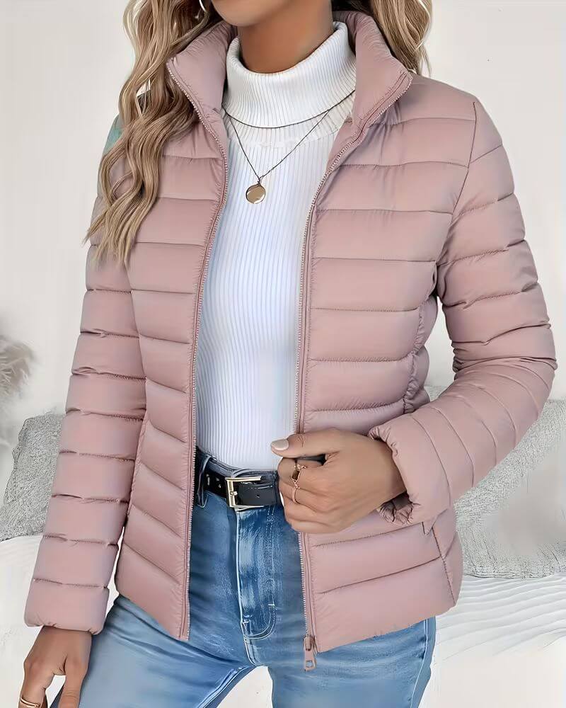 Fashionable women's cropped puffer jacket, quilted design, stand collar, & zip-up style. Versatile outerwear.