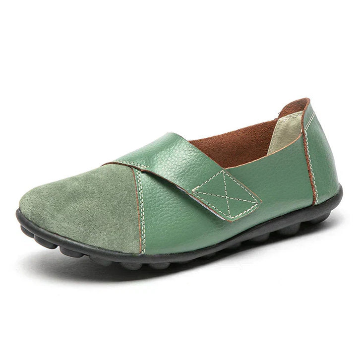 Women's slip-on comfort flats with a versatile round-toe and elegant stitched details.