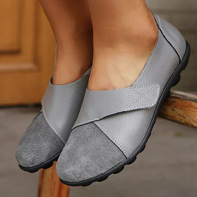 Versatile women's round-toe comfort flats with intricate stitching and easy slip-on design.