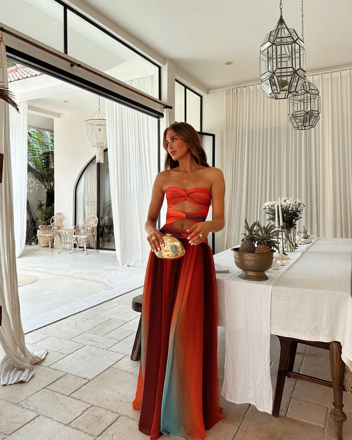 Women's strapless cut out maxi dress in a flowing summer style, perfect for elegant occasions.