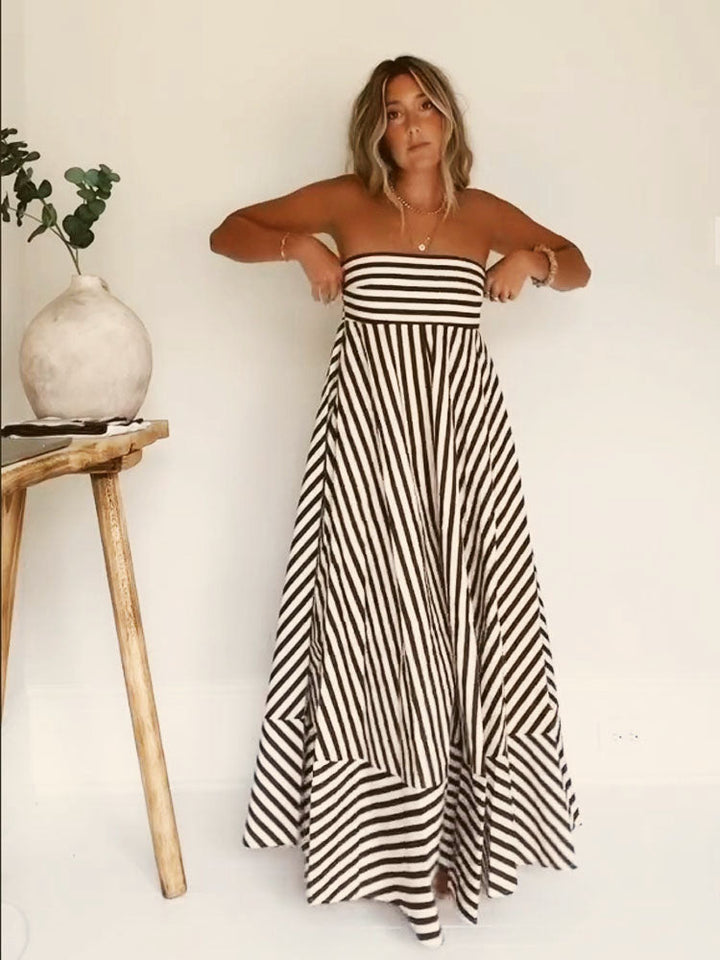 Women's strapless diagonal striped flare maxi dress. Elegant summer evening wear for special occasions.