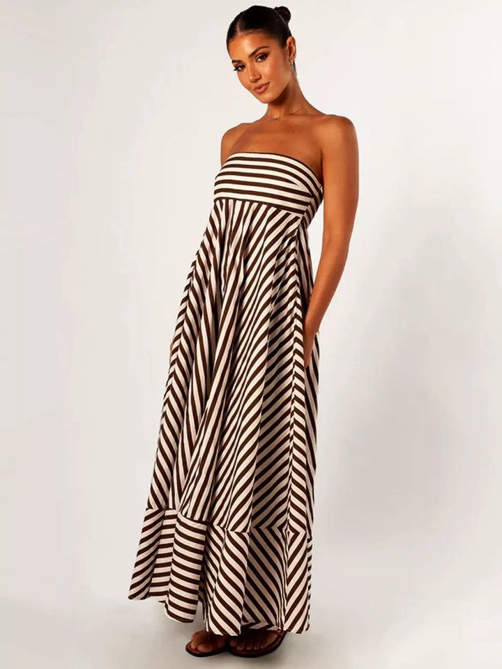 Stylish women's strapless striped flare maxi dress. Versatile long dress for evening wear or summer occasions.
