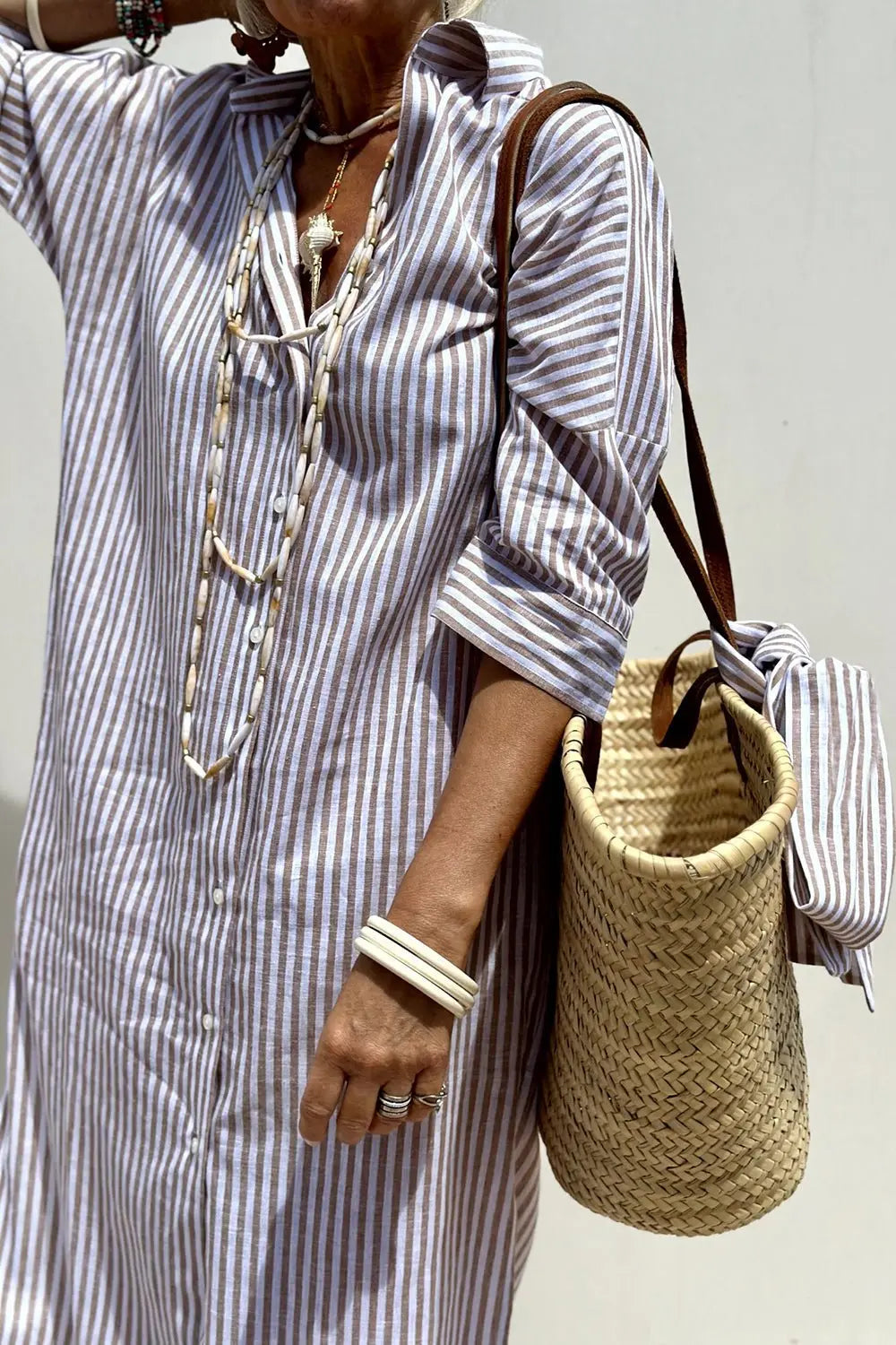 Chic striped button-down midi dress for women. Collared shirt dress, ideal for summer, brunch, or casual outings.