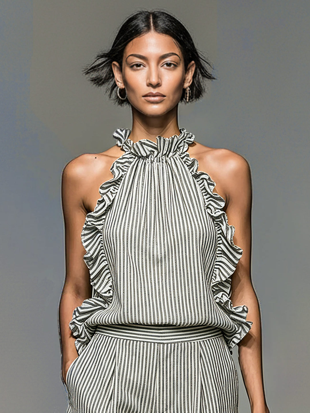 Chic women's matching set: striped halterneck top with ruffles and coordinating comfy shorts for summer.