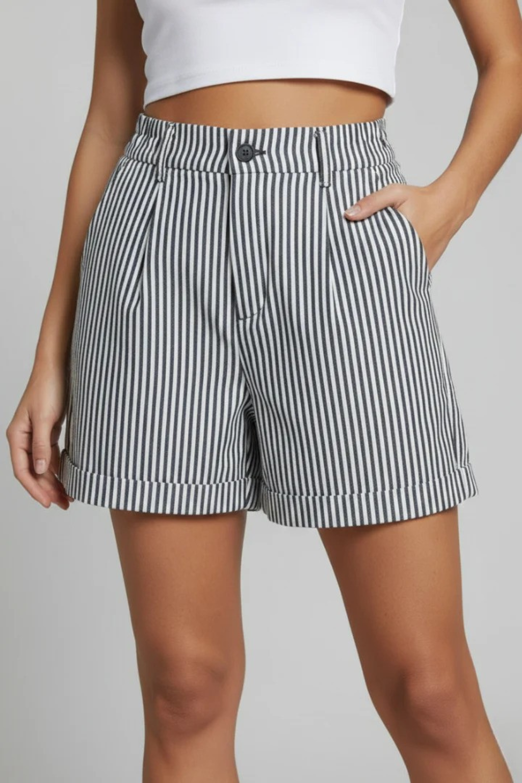Detail of the high waist and tailored waistband on women's striped shorts, creating an elegant & flattering look.