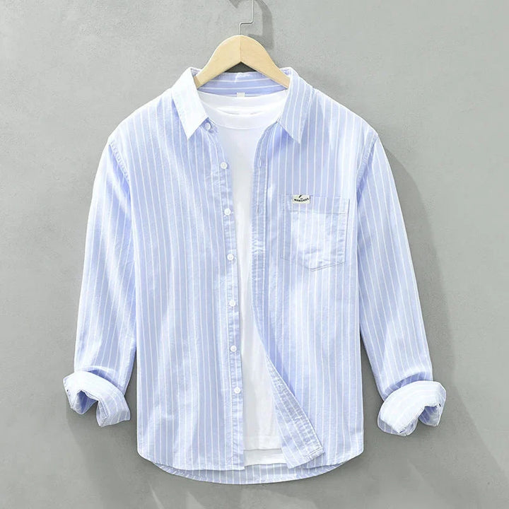 Women's striped long-sleeve button-up shirt with chest pocket. Casual and chic for everyday women's fashion.