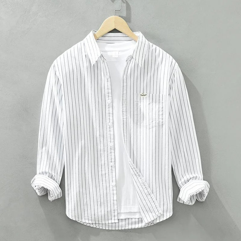 Classic blue and white striped women's casual long-sleeve shirt with chest pocket. Perfect for everyday style.