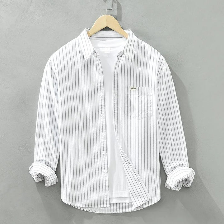 Classic blue and white striped women's casual long-sleeve shirt with chest pocket. Perfect for everyday style.