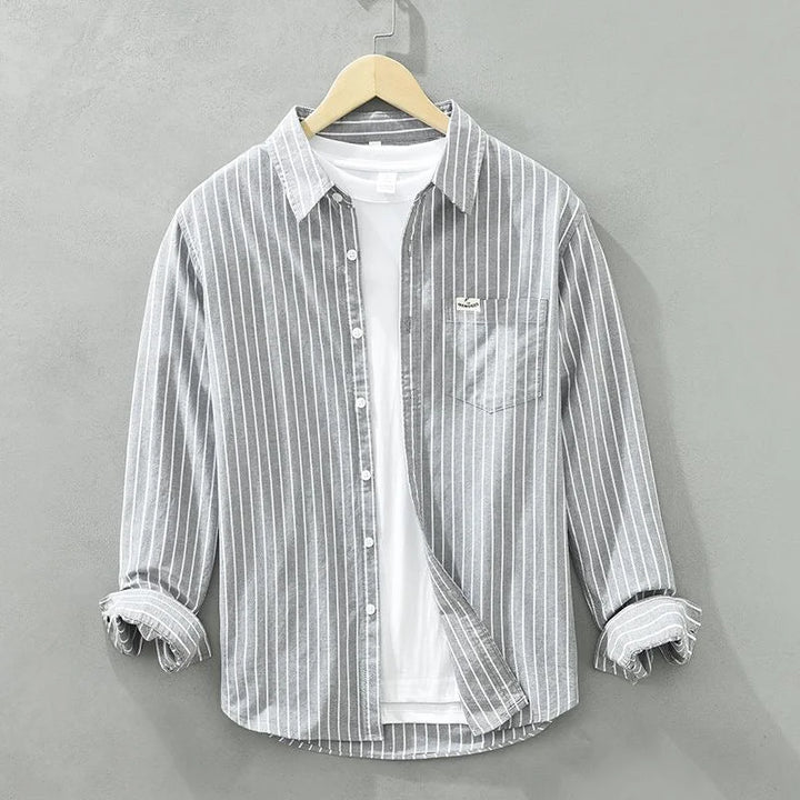 Relaxed fit women's striped long-sleeve button-up shirt. Comfortable and stylish for everyday women's fashion.