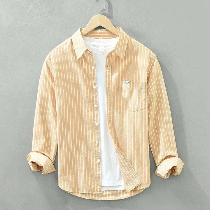 Chic women's striped long-sleeve button-up shirt. Ideal for spring, summer, and office casual wear. Versatile top.