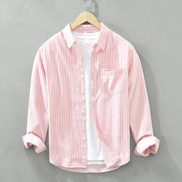 Stylish women's striped long-sleeve button-up shirt with practical chest pocket. Great for women's everyday wear.
