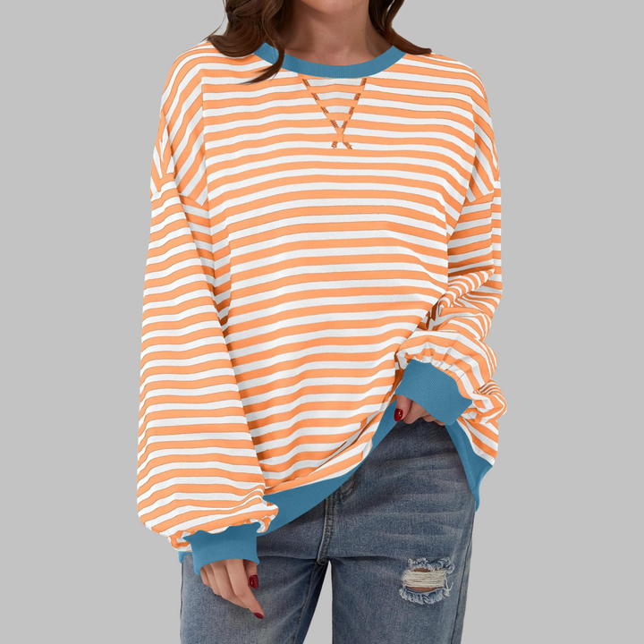 Cozy women's striped long sleeve pullover, relaxed fit. Essential for comfortable everyday fashion.