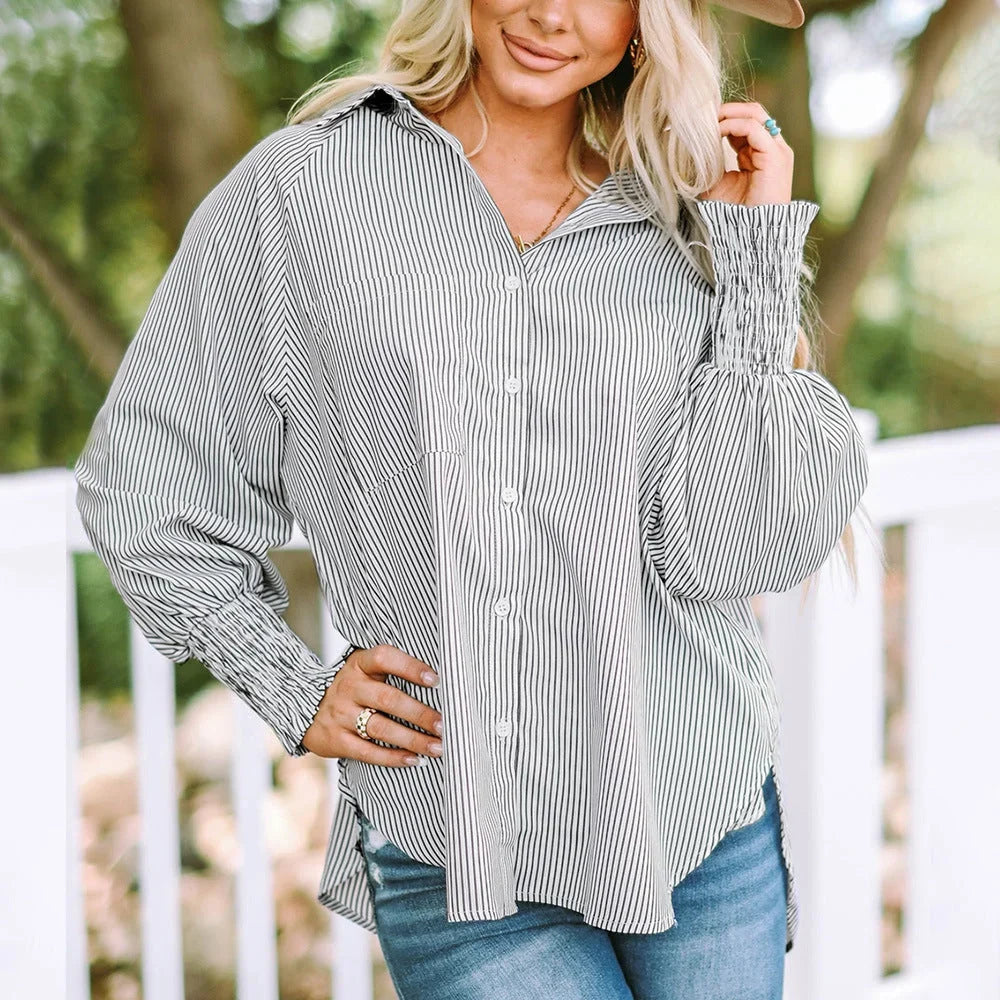 Stylish women's striped oversized button-down blouse with voluminous shirred balloon sleeves.
