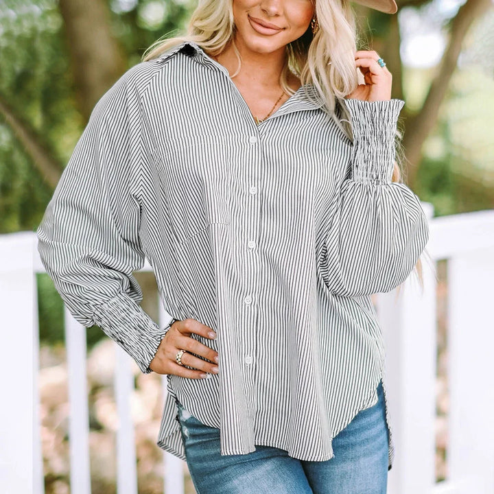 Stylish women's striped oversized button-down blouse with voluminous shirred balloon sleeves.