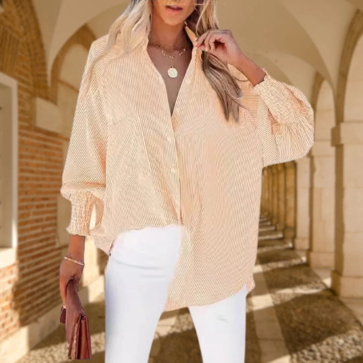 Women's stylish striped button-down shirt, oversized for comfort, with elegant shirred balloon sleeves.
